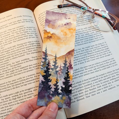 Be greeted by this peaceful autumn sunset watercolor bookmark whenever you open your book! This bookmark is 100% hand painted by me on professional grade watercolor paper and professional paints to ensure your bookmark lasts for years to come! It is double sided and comes with a cute line and dot print on the back! Due to each bookmark being hand painted, please understand that some variation and human error may occur! Print on the back will also vary due to patterns. This bookmark will come wit Sunset Watercolor, Moody Landscape, Watercolor Books, Purple Sunset, Watercolor Bookmarks, Watercolor Sunset, Watercolor Projects, Misty Forest, Fall Watercolor