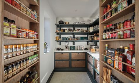 The hidden walk-in pantry is the pièce de resistance in what is already an impressive, one-of-a-kind kitchen. Feeling adventurous and having seen hidden pantries within other Tom Howley projects, it was cleverly integrated into the overall kitchen design, with double doors backed with bespoke racks, opening to reveal breathtaking pantry storage. Discover the design details and tour this inspiring kitchen on our blog. Luxury Green Kitchen, Walk In Larder, Hidden Pantries, Tom Howell, Drinks Area, Dream Kitchen Island, Integrated Wine Cooler, Tom Howley Kitchens, Walk In Pantry Ideas