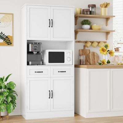 This 71-inch kitchen storage cabinets made from engineered wood with an eco-friendly paint finish. The white kitchen pantry features an open countertop, cable management, storage cabinets, 2 drawers, and an adjustable shelf. Perfect for organizing tableware, kitchen utensils, and storing food. Get this stylish and spacious pantry cabinet for your modern kitchen today! Finish: White | Ebern Designs Kalauni 71" Kitchen Pantry Storage Cabinets w / 2 Drawers 70.9 H x 31.5 W x 15.7 D in brownWood in Kitchen Pantry Storage Cabinets, Pantry Features, White Kitchen Pantry, Kitchen Storage Cabinets, Free Standing Kitchen Cabinets, Pantry Storage Cabinets, Tall Kitchen Cabinets, White Pantry, Beige Cabinets