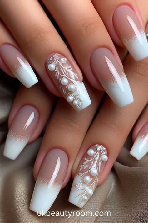 White nails are versatile, timeless, and suitable for any occasion. They offer a clean and polished look that complements any outfit. This post contains 39 white nail designs to help you stand out from the crowd. Cute, milk, milky, brown and, simple, short, gold and, gel, almond, coffin, square, with rhinestones, acrylic, with gems, with charms Wedding Nails Long Square, Short Coffin Bridal Nails, Wedding Nails For Bride Classy Bridal Pearl, Pretty Nails With Gems, Cream Wedding Nails For Bride, Cute Nails For A Wedding, Coffin Engagement Nails, Wedding Fall Nails For Bride, Wedding Ring Nails