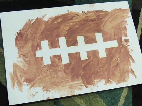 Tape Resist Football Painting #football #footballlessonplan #autumnlessonplan #falllessonplan #infant #toddler #childcare #childcarecourses #infantlessonplan Sport Crafts For Kids, Sport Crafts, Football Paintings, Toddler Sports, Football Crafts, Sport Craft, Football Themes, Sport Art, Daycare Crafts