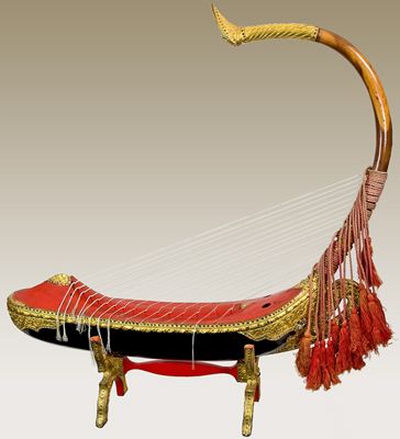 NMM 2375.  Saùng-gauk, Burma (Myanmar), ca. 1960. This highly decorative arched harp, formerly associated with the Buddhist dynasties that ruled Burma for centuries, is the national instrument of Myanmar. Similar harps can be seen in Burmese iconography dating back to the 2nd century AD. Beede Fund, 1978. Myanmar Musical Instruments, Myanmar Harp, Fictional Culture, Music Scales, Vintage Myanmar, Beautiful Instruments, Traditional Accessories, Myanmar Art, Music Museum