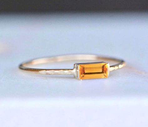 Beautiful citrine is set in solid 14k gold.  A solid gold band makes this suitable for everyday wear.  Great as a gift to yourself or a loved one. *Made to Order. If you would prefer the use of an earth mined ruby please convo me.  ◈ Gemstone : Natural Citrine ◈ Ring Thickness: ~ 1 mm ◈ Gem Dimensions: 5x2mm ◈ Cut: Baguette ◈ Metal: 14K Solid Gold (18K also available - please convo me for a quote) ◈ Gold Color: Choose from dropdown Packaging : All products purchased from us come in a gift box. I Opal Band Ring, November Birthstone Jewelry, Opal Band, Ethiopian Opal Ring, Solid Gold Band, Yellow Gemstones, Ring Art Deco, Citrine Ring, Ring Minimalist