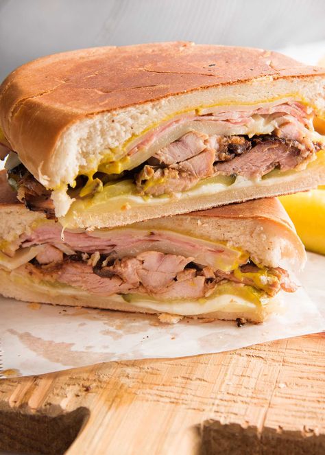 Cuban Sandwich (Cubano)! Here's how to make the BEST Traditional Cuban Sandwich, a.k.a. the Cubano, at home! Layers of mojo-marinated pork roast, ham, cheese, and pickles make this sandwich outstanding. Serve toasted grilled bread sandwich hot or cold! #simplyrecipes #porksandwich #bestcubansandwich #gameday #superbowl #cubano Pulled Pork Dishes, Cubano Recipe, Pan Cubano, Slow Cooked Pork Shoulder, Pork Ideas, Sandwich Cubano, Cubano Sandwich, Easy Pulled Pork, Cuban Bread