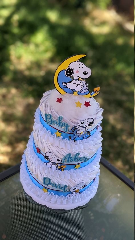 ~~ Please note: Shipping costs of this cake depend on your location and current shipping promo. The layers ship detached, are individually wrapped, and can easily be staked when ready to set up for the Baby Shower. ~~ This super cute Snoopy Baby Diaper Cake for a Baby Boy is made with approx. 65 Pampers Swaddlers Size 2. The layers are wrapped in premium ribbon, and embellished with stars and Baby Snoopys, and personalized cardstock decals.  ------------------------------------- Cake Ingredients: ------------------------------------- 65 Pampers Swaddlers Size 2  Premium Ribbon and Embelishments Caketopper ------------------------------------- Dimensions: ------------------------------------- Bottom Tier: 10 inches diameter Second Tier: 8 inches diameter Top Tier: 6 inches diameter Total he Snoopy Baby Shower Cake, Snoopy Baby Shower Decorations, Snoopy Baby Shower Theme, Snoopy Baby Shower, Cake For Baby Shower, Snoopy Baby, Cake For Baby, Cute Snoopy, Baby Snoopy