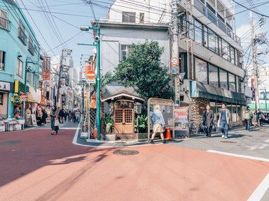 a district in japan on a sunny day with people walking in street Japan Neighborhood, Tokyo Neighborhoods, Visit Tokyo, Furano, Neighborhood Guide, Tokyo Street, Aesthetic Japan, Siem Reap, Design Hotel