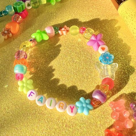 are you a magical fairy? then you need this bracelet ️✨ details ❥ approximately 6.5 inches & super stretchy 🐛 ❥ can be adjusted to your sizing :) 🌈 ❥ want this same design but want it to say something else? i can do that 🍀 Sanrio Beaded Bracelet, Candy Bead Bracelet Ideas, Kandi Bracelets Aesthetic, Scene Bracelets, Bracelets Kandi, Fairycore Jewelry, Rave Bracelets, Bracelet Y2k, Kawaii Bracelet