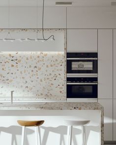 a minimalist white kitchen with cool white terrazzo countertops and a backsplash plus a pendant lamp is amazing Terrazzo Kitchen Countertops, Minimalist White Kitchen, Kitchen Terrazzo, Terrazzo Countertops, Terrazzo Countertop, Terrazzo Kitchen, Coral Kitchen, Clean Kitchen Design, Greige Kitchen