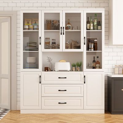 This kitchen corner pantry has a simple modern design that can fit into a variety of decorative styles. It has 1 open shelf, 3 utility drawers that slide easily, 4 toughened glass doors, and 2 opaque doors to keep your cutlery away from dust. With its compact design and powerful storage capacity, it will provide you with the perfect use experience. | Lark Manor Arwid Dining Cabinet Brown/White 78.7 x 63.0 x 46.0 in | YHGT4339 | Wayfair Canada Kitchen Hutch, Kitchen Storage Space, Pantry Storage Cabinet, Dining Cabinet, Cabinet Wood, Kitchen Pantry Cabinets, Kitchen Corner, Glass Cabinet Doors, Pantry Cabinet