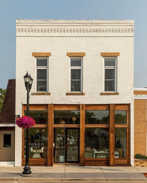 It's a perfect day to visit our beautiful shop! Did you know our space was designed using the sun as inspiration?🌞 We were lucky enough to work with @shelterdesigns to bring our vision to life. Token even won 1st place at the Midwest Home Design Awards gala for Retail Interior Design!✨ City Store Fronts, Quaint Shops Store Fronts, Store Door Design Shop Fronts, Commercial Retail Architecture, Storefront Interior Design, Retail Store Exterior Design, Furniture Store Exterior, Gift Shop Exterior Design, Small Business Building Exterior