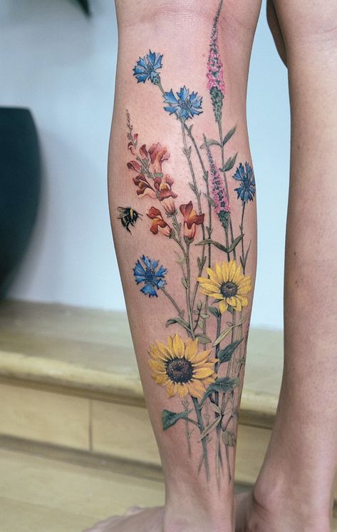 Flower Leg Tattoos Women Color, Watercolour Wildflower Tattoo, Flower Tattoos For Women Sleeve, Gardening Tattoos For Women, Pretty Flower Tattoos For Women, Floral Garden Tattoo, Leg Tattoos Color, Flower Shin Tattoo, Wildflower Leg Tattoo