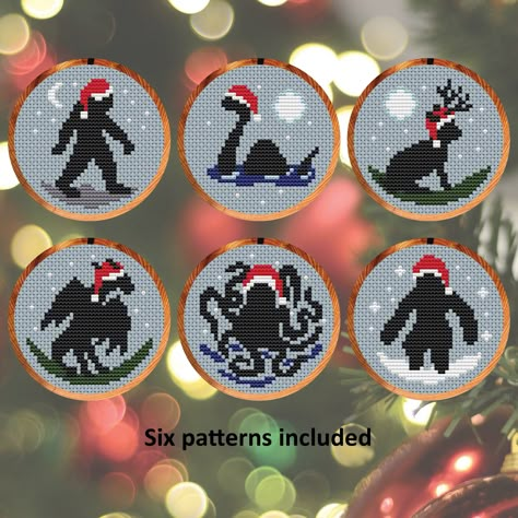 These instant download booklets contain six cross stitch patterns to make this fun and easy to stitch collection of Cryptids in Christmas Hats. On 14 count aida the patterns fit in 3 inch hoops to hang on the tree, or they can also be stitched as Christmas cards.  The cryptids featured are: Sasquatch/Bigfoot, Loch Ness Monster, Jackalope, Jersey Devil, Kraken and Yeti. The set uses 6 colours to stitch. It uses only full cross stitches; no backstitch or fractional stitches. Suitable for all skill levels - comprehensive cross stitch instructions are included. Stitch on fabric of your colour choice (images are shown on blue fabric). You will receive three PDF instant download files: * Five page booklet with all the charts in colour blocks with symbols, with a DMC thread key and a colour pictu Things To Cross Stitch On, Free Dragon Cross Stitch Pattern, Cross Stitch Coaster Patterns, Sasquatch Cross Stitch, Nerdy Cross Stitch Patterns Free, Cross Stitch Christmas Patterns Free, Cryptid Cross Stitch Pattern, Krampus Cross Stitch, Unique Cross Stitch Patterns Free