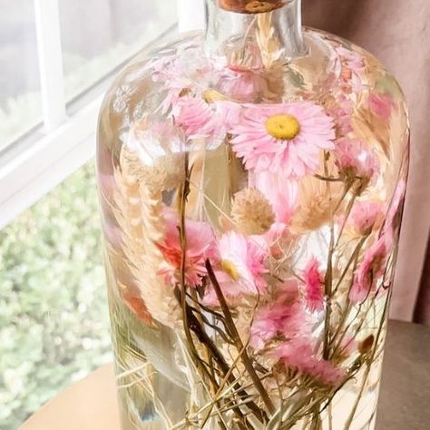 Janine Graff on Instagram: "Herbarium Jars🌸 Preserve cherished memories and capture the essence of special moments using any jar with a cork or lid, dried, pressed flowers + plants and baby oil! I recently learned about Japanese Herbariums and the art of preserving dried flowers in oil for display. I chose to make a larger herbarium, but you can create all different sized displays using any type of jar or container that you can seal with cork or a lid. Directions- - Cut dried flowers to yo Baby Oil Flower Jar, Preserve Flowers In Oil, Flowers In Baby Oil, Preserving Dried Flowers, Japanese Herbarium, Janine Graff, Swim Banquet, Herbarium Art, Wine Lifestyle