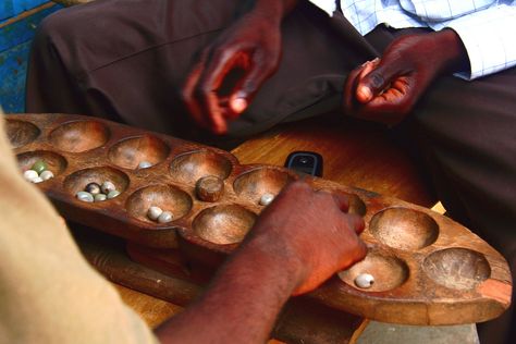 Traditional African game in the midst of blossoming technology in Kumasi, Ghana. Generally classified as the Mancala family of games, it is also known as Ayo (Yoruba), Awalé (Côte d'Ivoire), Wari (Mali), Ouri, Ouril or Uril (Cape Verde), Warri (Caribbean), Adji (Ewe), and Awélé (Ga). Commonly referred to in English as Awari. African Colonization, Games To Play Outside, Mancala Game, African Proverb, Play Based, Play Based Learning, Old Games, Summer Camp, Critical Thinking