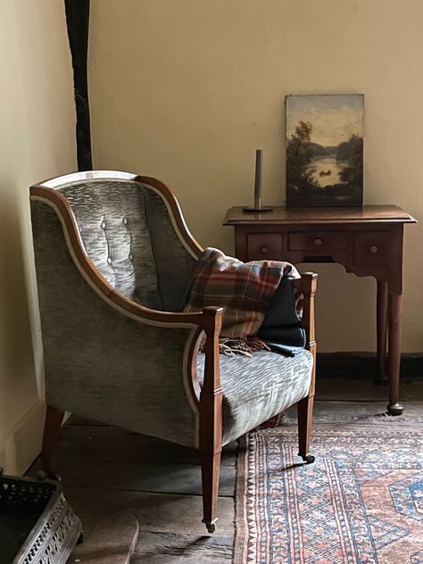 An old chair by the fire place, an antique rug, and a picture from a junk shop. Nothing here is particularly grant, but the overall effect is if timeless elegance in the Essex cottage Cottage Armchair, Antique Reading Corner, Cottagecore Armchair, Vintage Armchair Aesthetic, Vintage Wingback Chair Living Room, Antique Arm Chair, Armchair Books Edinburgh, Chair Reupholstery, Barn Bedrooms