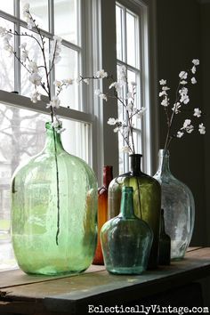 love this demijohn bottle collection with spring flower stems from World Market eclecticallyvintage.com Decorate With Green, Vibeke Design, Bottle Collection, Rustic Crafts, Flower Stems, Vintage Bottles, Green Decor, Deco Floral, Affordable Home Decor