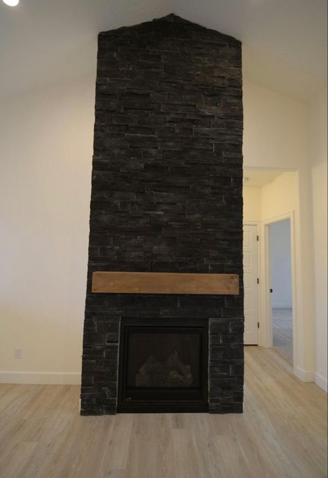 Black Stone Fireplace With Built Ins, Black Stone Outdoor Fireplace, Black Ledger Stone Fireplace, Black Stone For Fireplace, Black Stack Stone Fireplace, Black Stone Veneer Fireplace, Black Stone Fireplace Modern, Black Wood Burning Fireplace, Black Painted Fireplace Stone