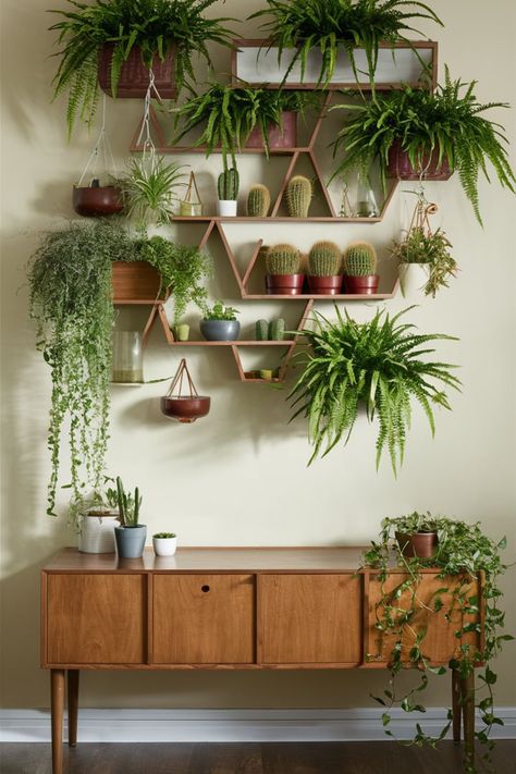 Design a lush living wall with staggered wooden shelves to showcase ferns, cacti, and hanging plants. Add a bohemian touch to your home with this eco-friendly decor idea. #LivingWallDesign #BohoGreenery #PlantWallIdeas #HomeDecorTrends #WoodenShelves #IndoorJungle #EcoFriendlyDecor #FernsAndCacti #GreenInteriorStyle #BohemianLiving Plant Wall Dining Room, Plant Wall Indoor Living Rooms, Plant Wall Shelf Ideas, Plant Wall Indoor, Plant Wall Shelf, Cascading Plants, Living Wall Indoor, Wood Corner Shelves, Green Inspo