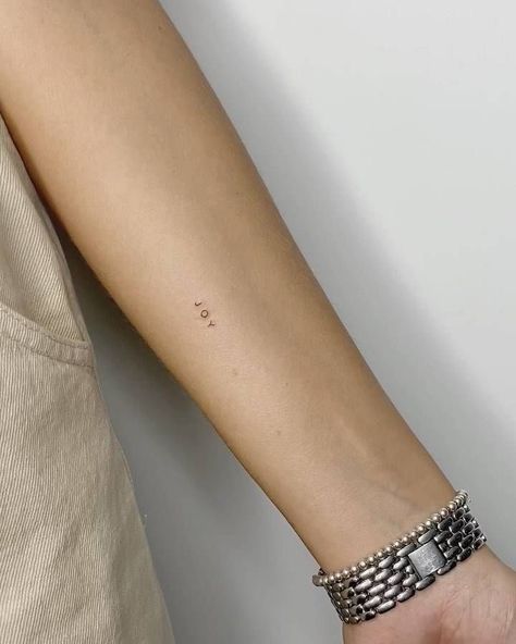 Minimalist Tattoo Arms Women, Words Tattoo Minimalist, Fine Line Back Of Arm Tattoo, Count It All Joy Tattoo, Minimalistic Arm Tattoo, Mini Tattoos Arm, Joy Tattoo Ideas, Joy Tattoo, Tiny Tats