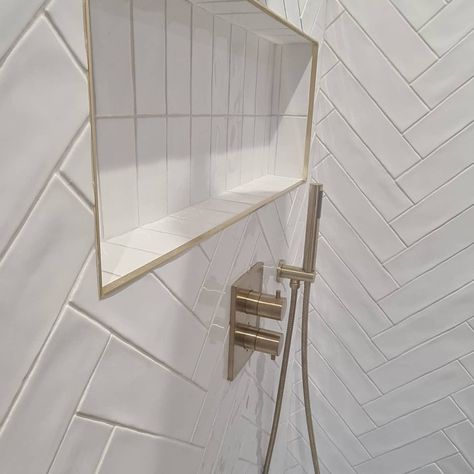 Herringbone Tile Shower Ideas, Shower Niche Herringbone Tile, Herringbone Tile Wall Bathroom, Chevron Tile Shower Wall, Shower Trim Ideas, Shower Herringbone Tile, Tile Baseboard Bathroom, Herringbone Tile Shower Wall, Herringbone Bathroom Wall