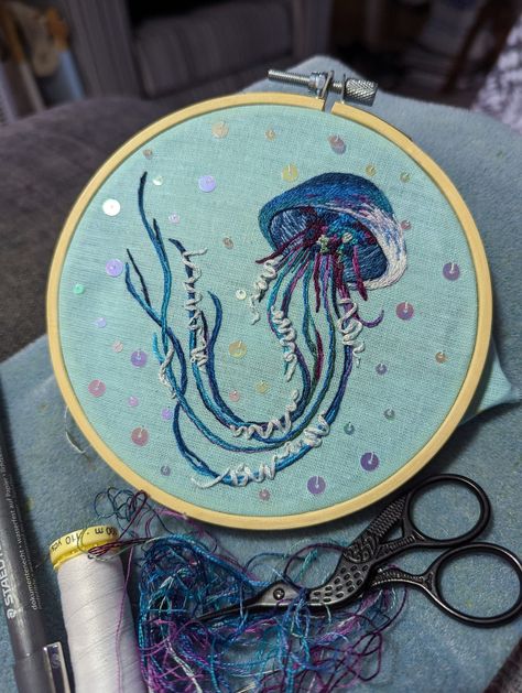 Jellyfish hand embroidered mini hoop Simple Blue Background, Diy Embroidery Thread, Diy Broderie, Animal Embroidery Designs, Embroidery Threads, Ribbon Yarn, French Knots, Animal Embroidery, Blue Embroidery