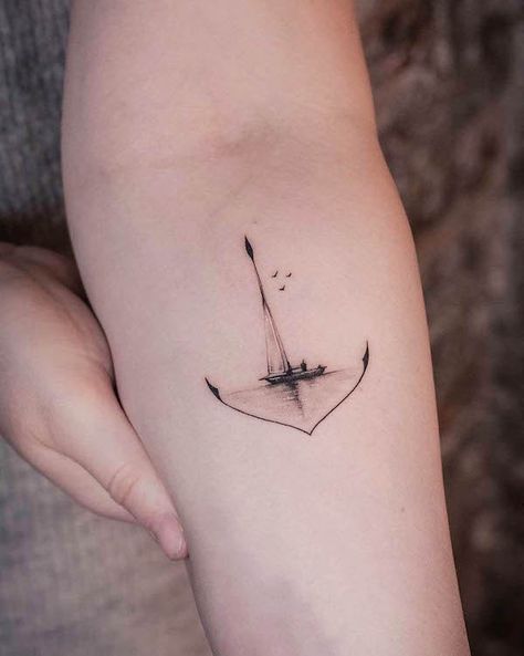 67 Meaningful Tattoos That You Won't Regret - Our Mindful Life Nautical Hand Tattoos For Women, Hammock Tattoo Ideas, Sailing Tattoo Ideas, Tiny Ship Tattoo, Light House Tattoo Minimalist, Grow Through It Tattoo, Simple Ship Tattoo, Sailing Tattoos For Women, Meaningfully Tattoos