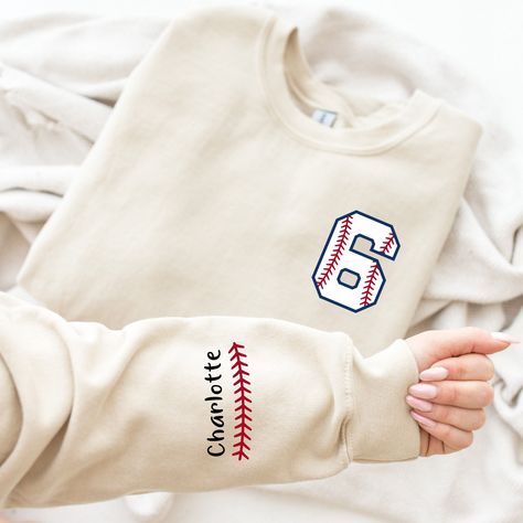 Custom  Baseball Sweatshirt, Custom Baseball Mom Sweatshirt, Custom Name and Number Baseball Sweater, Baseball Season, Baseball Mom Welcome to our cozy corner of comfort and style! We are thrilled to have you here at CozzyBoutigue, where every thread is woven with care and warmth. PRODUCT DETAILS Collar, shoulders, armholes, cuffs and hem double-needle stitched - 1 x 1 rib with spandex Features a crewneck - Relaxed fit - Unisex - 50% cotton 50% polyester HOW TO ORDER 1- Please review all photos, 2- Choose your size and color from the drop-down menus, 3- Click the "add to cart" button, 4- Go back for another product and go to 1.2.3. repeat the steps. CARE INSTRUCTIONS - Turn it upside down and machine wash at low temperature on the delicate programme. - Dry on a low heat setting - Do not bl Baseball Mom Sweater, Long Sleeve T-shirt For College Baseball Season, Sporty Crew Neck Soft-washed Sweater, Collegiate Cotton Sweatshirt For Baseball Season, Cotton Baseball Season Sports Sweatshirt, Cotton Sweatshirt For Baseball Season Sports, Baseball Season Fan Apparel Cotton Sweatshirt, Baseball Season Cotton Fan Apparel Sweatshirt, College Baseball Season Long Sleeve Sweatshirt