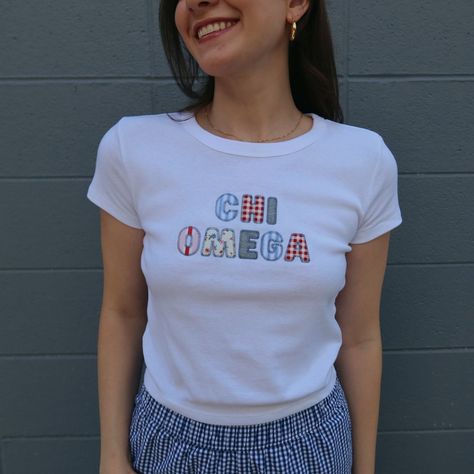 This adorable bella + canvas baby tee is sure to be your next go to tee for recruitment, PR, big little, or just pairing with jeans for class! Your sorority name or nick name will be spelled out (12 character limit) in 5 different fun blue, red & pink fabrics! Each design has the same fabrics, however displayed in a unique pattern each time, no two baby tees will be the same! The model is a 4, wearing a size small white baby tee. Bulk order pricing available, reach out to us via email info@thele Sorority Patchwork Shirt, Embroided T Shirts, Sorority Shirt Ideas, Sorority T Shirt Designs, Sorority Themes Recruitment, Sorority Merch Apparel Design, Sorority Merch Ideas, Big Little Themes, Theta Merch