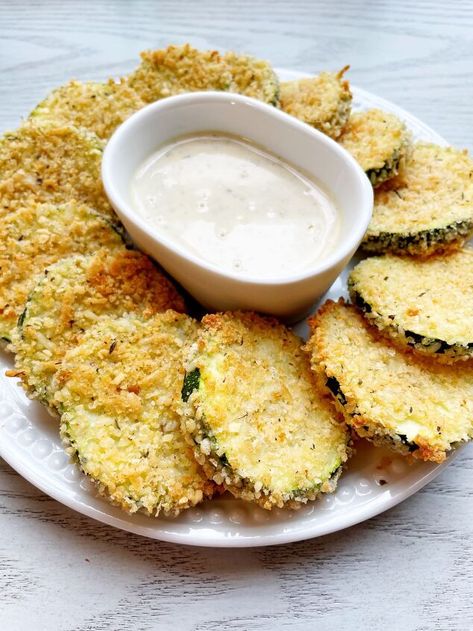 These Easy Oven Baked Zucchini Chips are lighter than fried zucchini but still as delicious! They are breaded and baked until your desired crispiness and color. Serve these crispy baked zucchini chips as an appetizer, snack or as a side to your main dish. Oven Baked Zucchini Chips IngredientsFor these zucchini chips you will only need a handful of ingredients: Zucchini Flour, any kind (all-purpose, whole wheat and gluten free have all been tested) Eggs Italian Seasoned Bread… Oven Baked Zucchini Chips, Oven Baked Zucchini, Baked Zucchini Chips, Oven Roasted Corn, Tomato And Onion Salad, Zucchini Chips Baked, Fried Zucchini, Baked Zucchini, Bake Zucchini