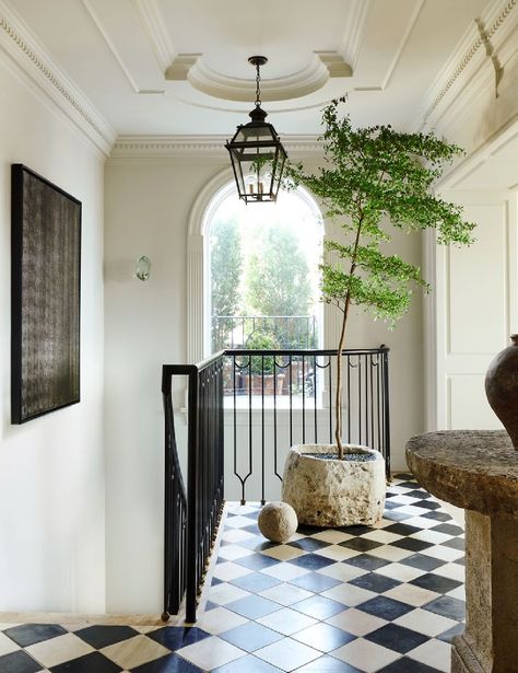 Entry with checkered floor and black railing in Nate Berkus & Jeremiah Brent Manhattan townhouse with 1920s architecture, neutral palette, plaster paint, and marble. AD (photo: Kelly Marshall). #nateberkus #nytownhouse Stairwell Chandelier, Jeremiah Brent, Checkerboard Floor, Nate Berkus, Vinyl Tiles, Step Inside, Architectural Digest, Railing, Design Inspo