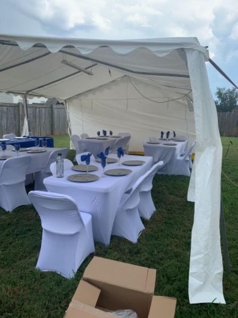 Create a top-notch tent party arrangement by organizing your event in the outdoors and ooze sophisticated elegance all around. Cover your party tables with white spandex tablecloth and chairs with white spandex covers. Create an elegant table setting by arranging silver chargers along with clear disposable flutes and further highlight their visual appeal by tugging in royal blue polyester napkins. This simple yet highly chic tabletop will elevate the aesthetics of your party up a notch. Outdoor Tent Party, Event Decor Ideas, Party Decorations Table, Silver Chargers, Tent Party, White Spandex, White Tablecloth, Party Tables, Blue Napkins