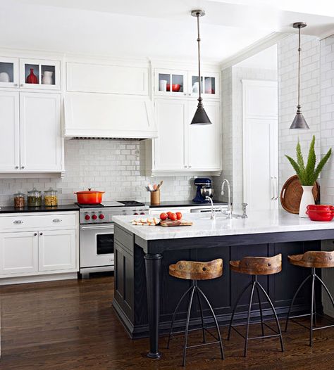 A sleek black breakfast bar adds a touch of elegance to this gorgeous kitchen. Tour the rest of this renovated farmhouse: http://www.bhg.com/home-improvement/remodeling/before-and-after/farmhouse-renovation/?socsrc=bhgpin051713blackbreakfastbar=4 Island Attached To Wall, Серая Кухня, Black Island, Farmhouse Renovation, Kabinet Dapur, Kitchen Black, Chef's Kitchen, Counter Tops, White Cabinets