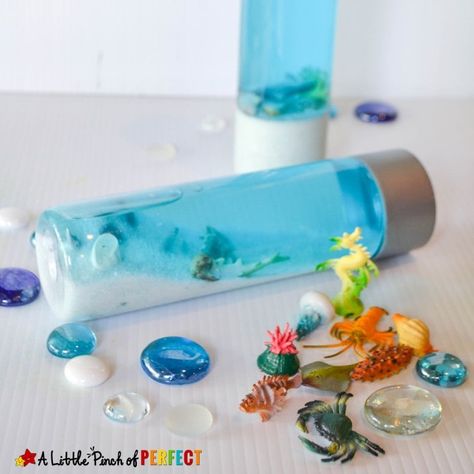 Mini Aquarium in a Bottle: Ocean Sensory Play to Learn and Explore - Ocean Sensory Play, Sensory Bottles Preschool, Ocean Sensory, Cupcake Liner Crafts, Calm Down Bottle, Discovery Bottles, Fun Summer Crafts, Mini Aquarium, Glitter Jars