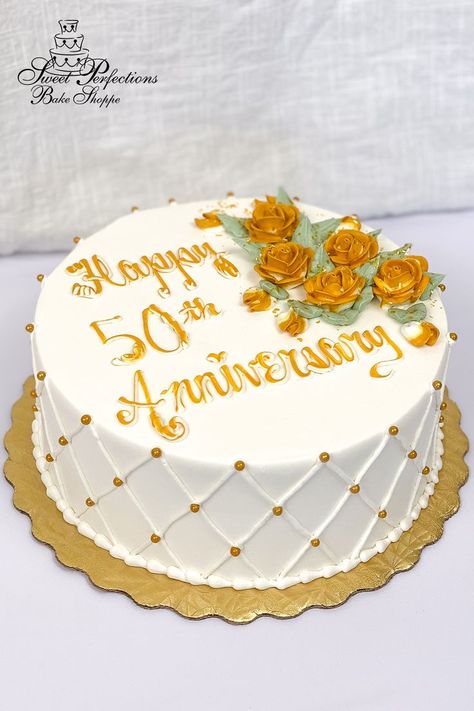 Celebrate a half century of love with cake especially designed for a golden anniversary. You choose your size and flavors, and we’ll ice it in our signature vanilla buttercream, add buttercream quilting and gold pearls on the side, then pipe a spray of gold roses with a touch of edible glitter next to your inscription. This simple design idea is available to order for your party right off our website! Minimum seven days’ notice; local pickup only. #spbakeshoppe Wedding Anniversary Cake Design Simple, Simple Anniversary Cakes, Anniversary Cake Designs, 50th Anniversary Cakes, Custom Desserts, Simple Cake Designs, Gold Roses, Wedding Anniversary Cake, Blue Cakes