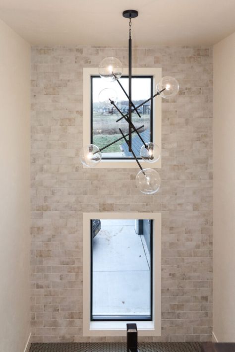 White brick accent wall in staircase. Modern Brick Accent Wall, Brick Accent Wall Entry Way, Light Brick Accent Wall, Brick Staircase Wall, Stairway Accent Wall With Window, Brick Accent Wall Staircase, Faux Brick Wall Staircase, Stairwell Accent Wall With Window, Brick Wall Staircase