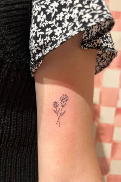 An arm with a fineline tattoo of carnations. Carnation Wrist Tattoo, Dainty Carnation Tattoo, Small Carnation Tattoo, Carnation And Rose Tattoo, Carnation Tattoo Design, Delicate Tatoos, Back In The Future, Carnation Flower Tattoo, Single Rose Tattoos