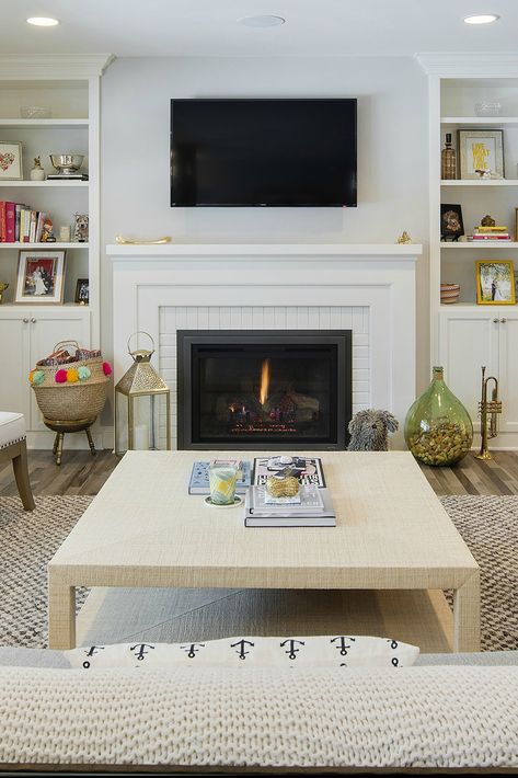 Thoughtful pops of color and layers of nubby textures lend this living room a comfortable, lived-in feel. Installing our Escape Gas FireBrick Insert allowed for a seamless, clean-looking hearth surrounded by a white-on-white brick and mantle combination. And with Direct Vent technology, putting a TV above the fireplace is 100-percent safe. Photo c/o @stonewoodllc. Tv Above Fireplace, Painted Brick Fireplaces, Gas Fireplace Insert, Fireplace Built Ins, Fireplace Insert, Fireplace Remodel, Gas Fire, Home Fireplace, Fireplace Makeover