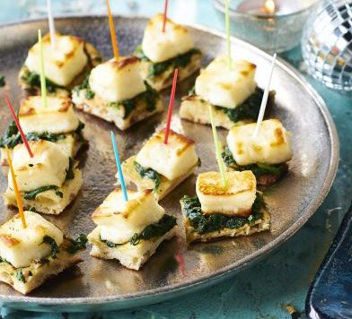 Naan, Spinach and halloumi bites: Wilt spinach with garlic and spices, then pile onto small, warm pieces of naan bread and top with halloumi for an attractive vegetarian canapé Halloumi Bites, Vegetarian Canapes, Ella Vegan, Nibbles For Party, Vegetarian Christmas, Christmas Buffet, Buffet Ideas, Naan Bread, Xmas Food