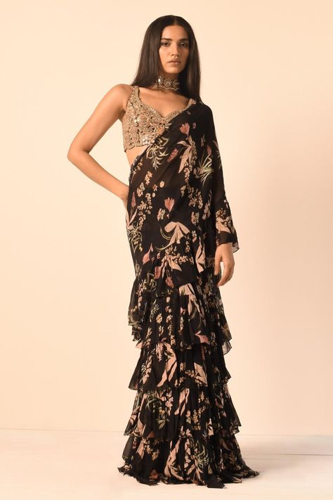 Black floral print tiered ruffle saree with blouse Sarees Black, Arpita Mehta, Haldi Outfits, Ruffle Sarees, Floral Print Sarees, Lehenga Blouse Designs, Ruffle Saree, Black Floral Blouse, Indian Bridal Fashion