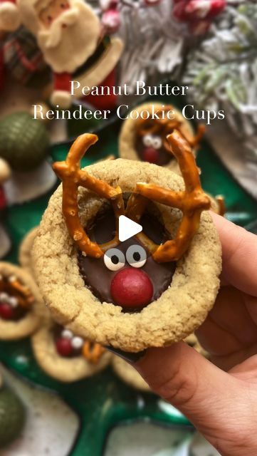 Madison Vegan on Instagram: "Peanut Butter Reindeer Cookie Cups 🦌 are so easy to make and have that salty-sweet combo everyone loves!  *1 package sugar cookie dough (12 count) I used @sweetlorens  *24 unwrapped mini dark chocolate peanut butter cups  *24 mini pretzels cut in half *candy eyes *red chocolate gems   Instructions: *Preheat heat oven to 325F *Generously grease a mini cupcake pan. *Place one cookie dough piece into each mini muffin cavity. Bake until cookies are golden brown, about 11-13 minutes. *Remove the pan from the oven, carefully press a peanut butter cup into the cookie. Then top with a mini pretzels for antlers, eyes, and a gem nose. *Let the cookies cool in the pan for about 15 minutes.  *Remove cookies from the pan and enjoy.  *Stored at room temperature, the cookies Peanut Butter Reindeer Cookie Cups, Reindeer Cookie Cups, Reindeer Peanut Butter Cookies, Reindeer Cookies With Pretzels, Pretzel Reindeer, Peanut Butter Reindeer Cookies, Rudolph Cookies, Gingerbread Cookie Dough, Dark Chocolate Peanut Butter