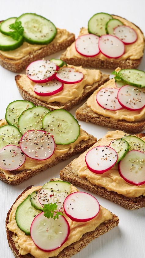 Hummus Veggie Toast is a delightful and healthy option for a quick meal or snack. Whole-grain toast serves as the base, spread with creamy, savory hummus and topped with thinly sliced cucumbers and radishes. A sprinkle of sesame seeds adds a touch of nuttiness and extra crunch. A perfect recipe for breakfast and brunch. Radish Breakfast, Veggie Toast, Fluffy Vegan Cinnamon Rolls, Vegan Toast, Berry Toast, Vegan Brunch Recipes, Creamy Hummus, Recipe For Breakfast, Vegan Cinnamon Rolls