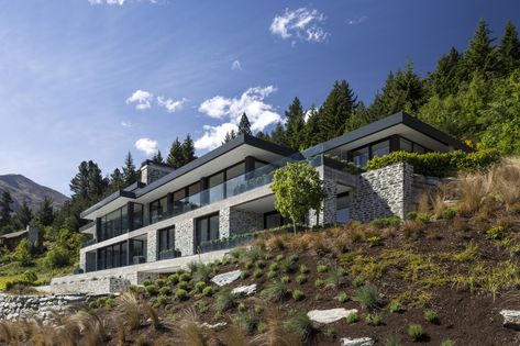 Large house on difficult steep slope is partly dug… | Trends Steep Hillside House, Steel Pavilion, House Built Into Hillside, Houses On Slopes, Slope House Design, House On Slope, Sloping Lot House Plan, Stone Exterior Houses, Slope House