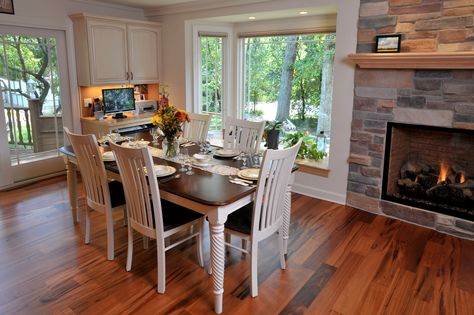 A view of the dining room table. White walls contrast against the Brazilian cherry hardwood flooring. Cherry Wood Floors Dining Room, Dining Room With Cherry Wood Floors, Dining Room Table White, Brazilian Cherry Hardwood Flooring, Open Concept Dining Room, Cherry Hardwood Flooring, Cherry Wood Floors, Cherry Floors, Birch Cabinets