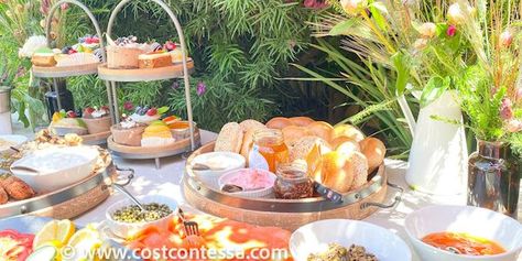 Sunday Brunch Casual Buffet with Bagels, Lox, Green Brunch Board and Desserts - Most of which we got at Costco! | Complete Boho Budget Brunch Guide at CostContessa.com Costco Brunch Food, Brunch Buffet Tablescape Presentation, Costco Brunch, Costco Brunch Ideas, Brunch Buffet Tablescape, Brunch Party Menu, Buffet Tablescapes, Easter Brunch Ideas, Brunch Pastries