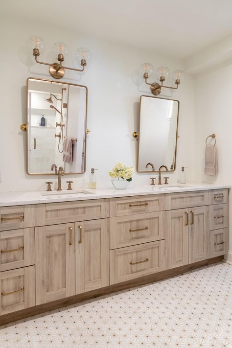 Transform your bathroom into a functional and stylish space. Our custom cabinetry will optimize every inch, making the most out of your small space.  This bathroom was designed by Paula Anane at Perspective Cabinetry & Design using Showplace cabinetry.  Contact us today to schedule your remodel in St. Louis, MO. #customcabinetry #bathroomremodel #perspectivecabinetry #showplacecabinetry Bathroom Vanity His And Hers, His And Her Bathroom Ideas Decor Double Sinks, Tan Vanity Bathroom, Beige Vanity Bathroom, Bathroom Ideas Double Vanity, Double Vanity Bathroom Decor, Bathroom With Gold Fixtures, Beige Bathroom Vanity, Bathroom Double Vanity