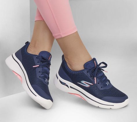 If you're seeking a comfortable athletic design with added support, then look no further in Skechers GO WALK Arch Fit - Uptown Summer. This lace-up vegan style features an engineered mesh upper with a removable Arch Fit insole and a lightweight ULTRA GO cushioned midsole. | Skechers Women's GO WALK Arch Fit - Uptown Summer Sneaker | Medium Width | Patented Skechers Arch Fit insole system with podiatrist-certified arch support | Podiatrist-designed shape developed with 20 years of data and 120, 000 unweighted foot scans | Removable insole helps mold to your foot to reduce shock and increase weight dispersion | Lightweight and responsive ULTRA GO cushioning | High-rebound Comfort Pillar Technology for added support | Crafted with 100% vegan materials | Breathable engineered mesh upper with a Vegan Style, Skechers Go Walk, Summer Sneakers, Wide Shoes, Vegan Fashion, Skechers Women, 2 Inch Heels, Navy Pink, Shoes Trainers