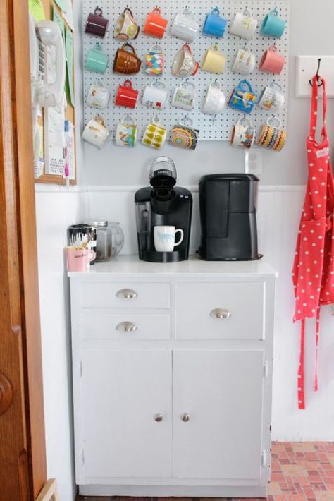 The best thing about pegboard organization is you can rearrange your holder when the look starts to get boring. Here, mugs are hung in a straight row, but it can easily be updated if you decide you want a more laid-back style.  See more at A Study in Contrasts » Coffee Cup Storage, Diy Coffee Station, Coffee Station Kitchen, Coffee Mug Display, Mug Storage, Pegboard Organization, Home Coffee Stations, Mug Display, Home Coffee Bar