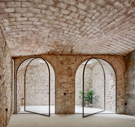 A 19th-Century Banana Warehouse Becomes a Bright, Adaptable Home - Dwell Exterior Doors With Glass, Internal Courtyard, Pivot Doors, Empty Room, Minimalist Architecture, Arched Windows, Interior Barn Doors, Stone Houses, Brickwork