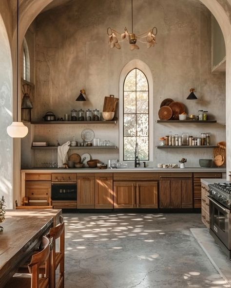 This stunning kitchen transforms the ethereal beauty of an abandoned church into a serene culinary haven. The high, vaulted ceilings and arched windows flood the space with natural light, creating a tranquil, almost sacred ambiance. Rustic wooden cabinetry and open shelves lined with glass jars and earthenware add a touch of simplicity and warmth. The minimalistic design of the stone countertops and the elegant pendant lighting fixture blend seamlessly with the historic charm of the architect... Kitchen With Arched Ceiling, Arched Ceiling Kitchen, Stone Kitchen Countertops, Stone Countertops Kitchen, Present Design, Elegant Pendant Lighting, Abandoned Church, Stone Kitchen, Vaulted Ceilings