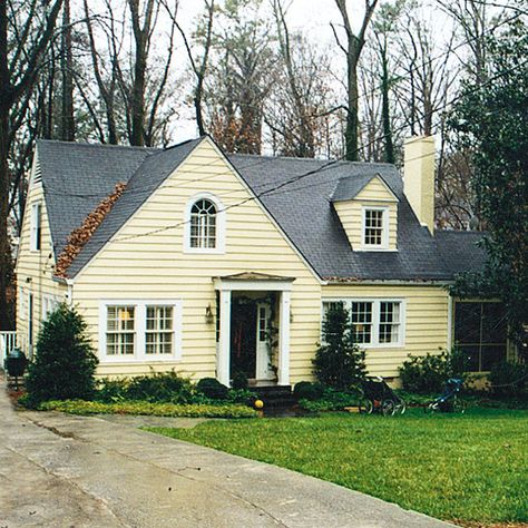 Odd window configurations, plain clapboard siding, and a nondescript porch gave the front exterior of this 1920s cottage very little personality. The owners were able to fix that with a curb appeal renovation you'll love. Cape Cod Exterior, Cape Cod House Exterior, Ranch House Exterior, Clapboard Siding, Exterior House Remodel, Shingle Siding, Home Exterior Makeover, Cape Cod House, Roof Colors